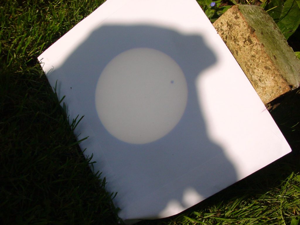 Transit of Venus photographed projected on paper through binoculars.